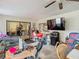 Spacious screened patio with seating and large TV at 18923 Rolling Oak Dr, Hudson, FL 34667