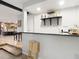 Modern wet bar with granite countertop and open shelving at 18923 Rolling Oak Dr, Hudson, FL 34667