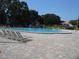 Community pool with people swimming and relaxing at 2000 World Parkway Blvd # 21, Clearwater, FL 33763