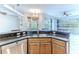 Spacious kitchen island with granite countertop and double sink at 2217 Terrace View Ln, Spring Hill, FL 34606