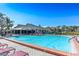 Community swimming pool with lounge chairs at 2217 Terrace View Ln, Spring Hill, FL 34606