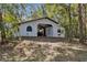 White barn with covered area and tractor at 22770 Skyview Cir, Brooksville, FL 34602