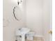 Small bathroom with pedestal sink and toilet at 22770 Skyview Cir, Brooksville, FL 34602