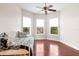 Bedroom with hardwood floors, daybed and ceiling fan at 22770 Skyview Cir, Brooksville, FL 34602