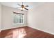 Hardwood floor bedroom with a ceiling fan and window at 22770 Skyview Cir, Brooksville, FL 34602
