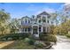 Two-story house with a wrap-around porch and landscaped yard at 22770 Skyview Cir, Brooksville, FL 34602