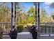 Charming front porch with view of landscaped yard and trees at 22770 Skyview Cir, Brooksville, FL 34602