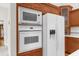 Built-in microwave and oven with a large refrigerator at 22770 Skyview Cir, Brooksville, FL 34602