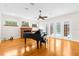 Living room with hardwood floors, fireplace, and grand piano at 22770 Skyview Cir, Brooksville, FL 34602