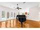 Living room with hardwood floors, fireplace, and grand piano at 22770 Skyview Cir, Brooksville, FL 34602