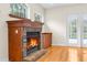 Cozy living room featuring a brick fireplace and hardwood floors at 22770 Skyview Cir, Brooksville, FL 34602