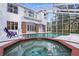 Screened pool, spa, and view of home's exterior at 22770 Skyview Cir, Brooksville, FL 34602