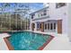 Screened pool, spa, and view of home's exterior at 22770 Skyview Cir, Brooksville, FL 34602