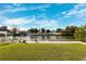 Grass lawn, canal view, and relaxing lounge chairs at 3215 Rose Arbor Dr, Hernando Beach, FL 34607
