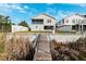 Wooden walkway leading to the canal behind house at 3215 Rose Arbor Dr, Hernando Beach, FL 34607