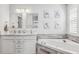 Spa-like bathroom featuring a double vanity and corner tub at 3215 Rose Arbor Dr, Hernando Beach, FL 34607