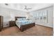 Bright bedroom featuring a king bed, window seating, and a ceiling fan at 3215 Rose Arbor Dr, Hernando Beach, FL 34607
