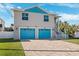 Two-story home with teal garage doors and paved driveway at 3215 Rose Arbor Dr, Hernando Beach, FL 34607
