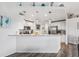 Modern kitchen with white cabinets, granite countertops, and stainless steel appliances at 3215 Rose Arbor Dr, Hernando Beach, FL 34607