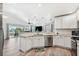 Open kitchen with granite island, stainless steel appliances & view to living area at 3215 Rose Arbor Dr, Hernando Beach, FL 34607