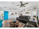 Spacious living room with leather couches, a teal door, and an open kitchen at 3215 Rose Arbor Dr, Hernando Beach, FL 34607