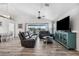 Open concept living area with hardwood floors, leather couches, and a large TV at 3215 Rose Arbor Dr, Hernando Beach, FL 34607