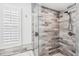 Large walk-in shower with modern gray tile at 3215 Rose Arbor Dr, Hernando Beach, FL 34607