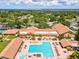 Community pool, clubhouse, and tennis courts are featured in this aerial view at 3259 Hilary Cir # 1C, Palm Harbor, FL 34684
