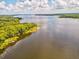 Wide shot of a tranquil lake with a shoreline lined with trees at 3259 Hilary Cir # 1C, Palm Harbor, FL 34684