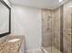 Bathroom with granite countertop, updated vanity, and a large glass shower at 3259 Hilary Cir # 1C, Palm Harbor, FL 34684