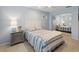 Serene bedroom with light blue walls, striped bedding, and mirrored closet at 3259 Hilary Cir # 1C, Palm Harbor, FL 34684