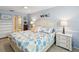 King-size bedroom with coastal decor and ensuite bathroom at 3259 Hilary Cir # 1C, Palm Harbor, FL 34684