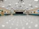 Large community room with stage and ample seating at 3259 Hilary Cir # 1C, Palm Harbor, FL 34684