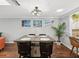 Bright dining area with a square table and four chairs, hardwood floors, and coastal decor at 3259 Hilary Cir # 1C, Palm Harbor, FL 34684