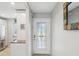 Bright entryway with glass door and kitchen peek at 3259 Hilary Cir # 1C, Palm Harbor, FL 34684
