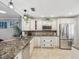 Spacious kitchen featuring granite countertops and stainless steel appliances at 3259 Hilary Cir # 1C, Palm Harbor, FL 34684