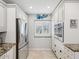 Modern kitchen with stainless steel appliances and ample cabinet space at 3259 Hilary Cir # 1C, Palm Harbor, FL 34684
