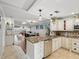 Open kitchen with island, granite countertops and stainless steel appliances at 3259 Hilary Cir # 1C, Palm Harbor, FL 34684