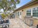 Relaxing patio with seating area and built-in grill at 3259 Hilary Cir # 1C, Palm Harbor, FL 34684