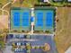 Aerial view of community tennis courts with parking at 3259 Hilary Cir # 1C, Palm Harbor, FL 34684