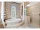 Elegant bathroom with soaking tub, walk-in shower, and tile flooring at 3414 Graycliff Ln, Brandon, FL 33511