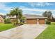 House with three-car garage and palm trees at 3414 Graycliff Ln, Brandon, FL 33511
