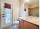 Bathroom with wood cabinets, toilet and exterior access at 3455 Barnweill St, Land O Lakes, FL 34638