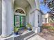 Elegant front entrance with double green doors and columns at 3455 Barnweill St, Land O Lakes, FL 34638