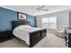 Main bedroom with a large bed, window, and sitting chair at 4332 Lamson Ave, Spring Hill, FL 34608