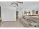 Spacious bonus room with a comfy couch and built-in shelving at 4332 Lamson Ave, Spring Hill, FL 34608