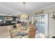 Round dining table with wicker chairs, overlooking the pool at 4332 Lamson Ave, Spring Hill, FL 34608