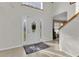 Bright entryway with tile flooring, staircase, and front door with glass at 4332 Lamson Ave, Spring Hill, FL 34608