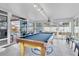 Bright game room with pool table and sliding glass doors at 4332 Lamson Ave, Spring Hill, FL 34608