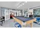 Relaxing game room with pool table and view into the garage at 4332 Lamson Ave, Spring Hill, FL 34608